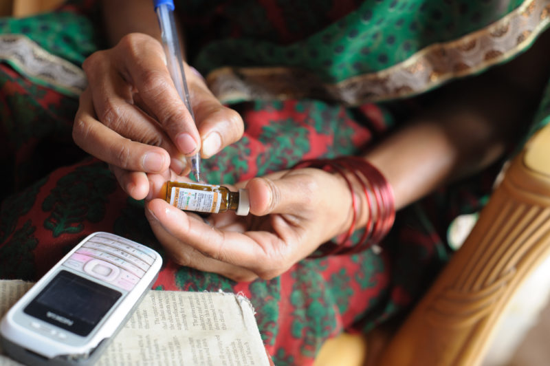 A community health worker uses a mobile data collection app to improve her diagnostic time