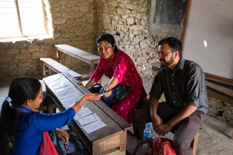 A mobile data collection app designer takes two community health workers through her tool