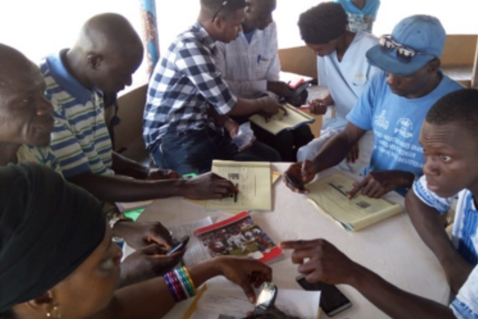 Frontline workers review results from their anti-malaria program supported by the DSME.