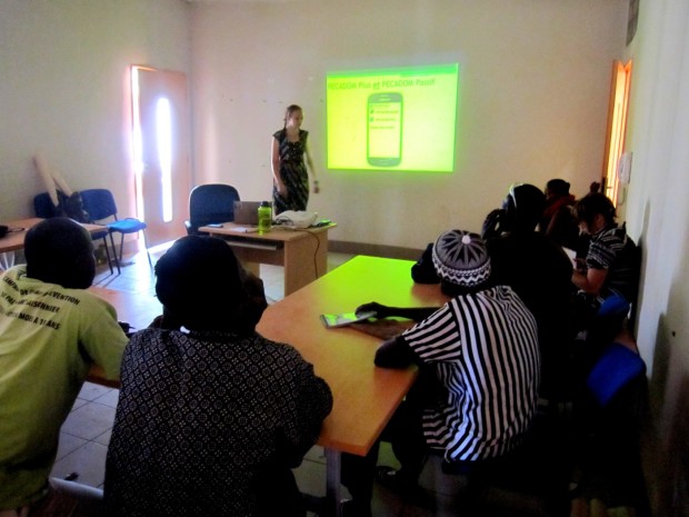 A group of community health workers attend a training for their mobile data collection app to fight malaria.